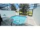 Enclosed pool area with clear blue water and a tranquil view of the surrounding landscape at 349 Captiva Dr, Davenport, FL 33896