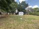 Large backyard with covered porch, mature trees and plenty of green space at 3535 Island Oaks N, Lakeland, FL 33805