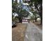 Cozy single-story home with a spacious driveway and mature trees providing shade at 3535 Island Oaks N, Lakeland, FL 33805