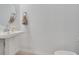 Half bathroom featuring a pedestal sink and neutral decor at 3617 Anibal St, Kissimmee, FL 34746