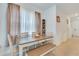 Dining room with a neutral-toned table, bench, and view to the hallway and front entry at 3617 Anibal St, Kissimmee, FL 34746