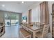 Dining room featuring a wood table, seating for six, and a view of the outdoor patio through a glass slider at 3617 Anibal St, Kissimmee, FL 34746