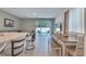Dining area with table, bench seating, and a view of the backyard through sliding glass doors at 3617 Anibal St, Kissimmee, FL 34746