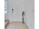 Bright entryway featuring tile flooring and a white front door with an electronic deadbolt at 3617 Anibal St, Kissimmee, FL 34746