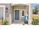Inviting front door with a charming blue chair, a 'Private Residence' sign, and tropical landscaping at 3617 Anibal St, Kissimmee, FL 34746