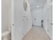Hallway with tile flooring leading to a half-bath and the front door at 3617 Anibal St, Kissimmee, FL 34746