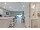Open floor plan, featuring a modern kitchen that flows into the dining area, half bath, and living room at 3617 Anibal St, Kissimmee, FL 34746