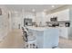 Modern kitchen featuring white cabinets, stainless steel appliances, and a large quartz island with bar seating at 3617 Anibal St, Kissimmee, FL 34746