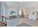 Bright, open-concept living room with tile floors, modern furniture, and a kitchen with stainless steel appliances at 3617 Anibal St, Kissimmee, FL 34746
