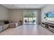 Living room with comfortable seating, a media console with television, and a glass slider to outdoor patio at 3617 Anibal St, Kissimmee, FL 34746