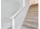 Carpeted stairway with white railing leads to the upper level of the home at 3617 Anibal St, Kissimmee, FL 34746
