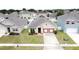 Aerial view of a well-maintained single-Gathering home featuring beautiful landscaping and a two-car garage at 3690 Maidencain St, Clermont, FL 34714