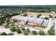 Exterior shot of a community school with surrounding trees and an open field at 3690 Maidencain St, Clermont, FL 34714