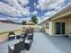 Backyard features an outdoor kitchen, dining area, and firepit, making it an entertainer's dream at 3690 Maidencain St, Clermont, FL 34714