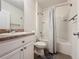 Clean and functional bathroom with a shower-tub combo, vanity, and modern fixtures, offering comfort and convenience at 3690 Maidencain St, Clermont, FL 34714