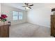 Spacious bedroom filled with natural light, features a ceiling fan, and neutral carpet at 3690 Maidencain St, Clermont, FL 34714