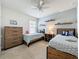 Charming bedroom featuring two beds, floating shelves, and a ceiling fan for added comfort at 3690 Maidencain St, Clermont, FL 34714