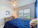 Inviting bedroom with plush carpeting, a comfortable bed, and a sunny window with wood dresser at 3690 Maidencain St, Clermont, FL 34714