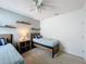 Bright bedroom featuring a twin bed, floating shelves and a neutral color palette at 3690 Maidencain St, Clermont, FL 34714