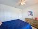 Comfortable bedroom with carpeting, a modern dresser, and plenty of storage space in the double closets at 3690 Maidencain St, Clermont, FL 34714