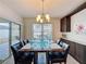Elegant dining room features a marble table with seating for eight, a chandelier, and outdoor access at 3690 Maidencain St, Clermont, FL 34714