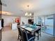 Open-concept dining room features a modern chandelier and sliding glass doors to the outside patio at 3690 Maidencain St, Clermont, FL 34714