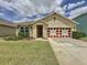 Charming single-story home features a well-manicured lawn, beautiful landscaping, and a welcoming entrance at 3690 Maidencain St, Clermont, FL 34714