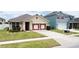 Charming single-story home with a well-manicured lawn, colorful garage, and inviting curb appeal at 3690 Maidencain St, Clermont, FL 34714