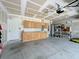 Unfinished garage features cabinets, shelving, and utility sink for added storage and convenience at 3690 Maidencain St, Clermont, FL 34714