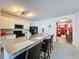 Open kitchen with an island, bar seating, and modern appliances at 3690 Maidencain St, Clermont, FL 34714