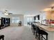 Open concept kitchen and living room shows kitchen island with bar seating and dining area at 3690 Maidencain St, Clermont, FL 34714