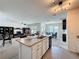 Open concept kitchen with bar seating, living room with built-ins, and dining area at 3690 Maidencain St, Clermont, FL 34714