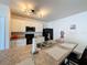 Well-equipped kitchen showcases an island with a sink, black appliances and white cabinetry at 3690 Maidencain St, Clermont, FL 34714