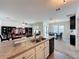 Open concept kitchen and living room provides an eat-in island and natural light at 3690 Maidencain St, Clermont, FL 34714