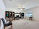 Bright living room features a ceiling fan and a built-in entertainment center for storage and media display at 3690 Maidencain St, Clermont, FL 34714