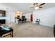 Open concept living room shows view into kitchen, bar seating, and ample natural light at 3690 Maidencain St, Clermont, FL 34714
