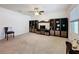 Spacious living room with carpet flooring, a ceiling fan, and a custom entertainment center with storage at 3690 Maidencain St, Clermont, FL 34714