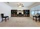 Bright living room features a ceiling fan and a built-in entertainment center for storage and media display at 3690 Maidencain St, Clermont, FL 34714