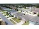Aerial view shows residences in a neighborhood with manicured landscaping, and well-spaced homes at 3690 Maidencain St, Clermont, FL 34714