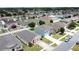 Overview of the residential neighborhood featuring many homes, mature trees, and manicured lawns from above at 3690 Maidencain St, Clermont, FL 34714