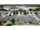 Aerial perspective capturing a residential neighborhood with views of a scenic lake and lush landscaping at 3690 Maidencain St, Clermont, FL 34714