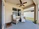 Covered patio featuring comfortable seating, fan and string lights for a relaxing outdoor experience at 3690 Maidencain St, Clermont, FL 34714
