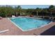 Community pool surrounded by lounge chairs and lush greenery offers a relaxing retreat at 3690 Maidencain St, Clermont, FL 34714
