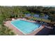Aerial view of the community pool with plenty of chairs, tables, and greenery at 3690 Maidencain St, Clermont, FL 34714