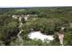 Aerial view of the community's beach volleyball court surrounded by lush greenery at 3690 Maidencain St, Clermont, FL 34714