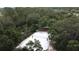Aerial view of the community beach volleyball court surrounded by lush trees at 3690 Maidencain St, Clermont, FL 34714