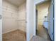 Walk-in closet featuring wire shelving and access to an adjacent bathroom at 3690 Maidencain St, Clermont, FL 34714