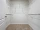 Open walk-in closet with wire shelving that maximizes storage capacity at 3690 Maidencain St, Clermont, FL 34714