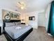Bedroom with black furniture, TV and king-size bed with gray bedding at 394 Orange Cosmos Blvd, Davenport, FL 33837