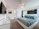 Spacious primary bedroom with ceiling fan and decoratively furnished with mounted TV at 394 Orange Cosmos Blvd, Davenport, FL 33837